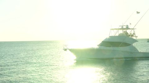MIAMI – FEBRUARY 17: Brand new luxury fishing boat navigates fast at the sunset during Miami International Boat Show on February 17, 2014 in Miami

