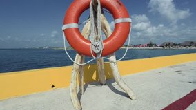 Shot of a lifesaver personal flotation device by the ocean water. 