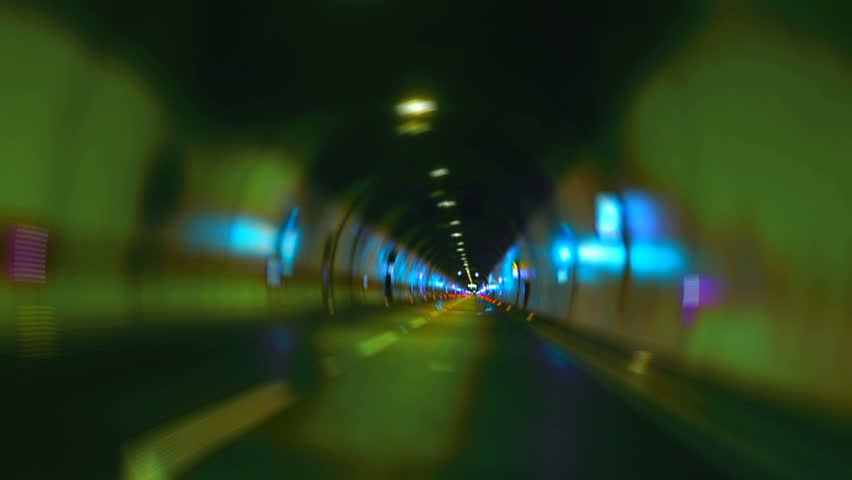 Car driving on highway tunnel looping high speed zoom