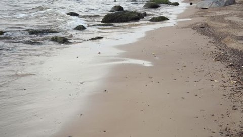 waves crushing on the beach sand