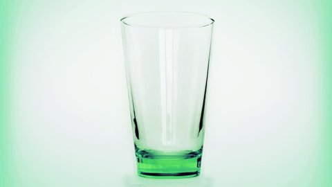 Pouring glass of water in high quality for fullHD green background 