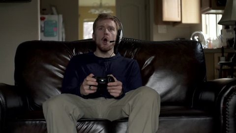A gamer guy gets frustrated when his teammates makes another mistake in slow motion. 