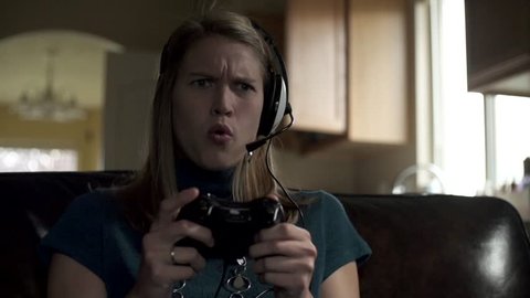 A young gamer lady loses a match in a game and yells "NO" in slow motion. 