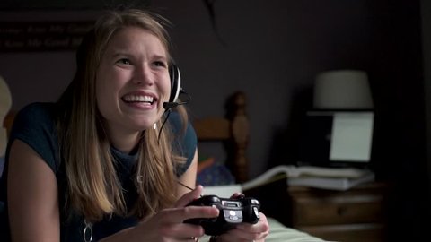 A woman is excited as she plays a game in slow motion. 