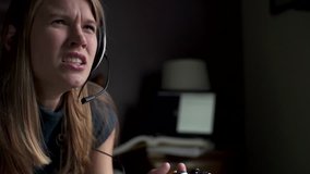 An angry gamer girl slams her controller down in slow motion. 