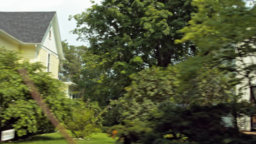 Driving plate: left view (passenger side), 1920s-30s timber-frame houses in Mid West US neighborhood.  Intended for compositing.  24mm lens, stabilized clip, originally recorded in 4K, UHD.