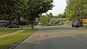 Driving plate: rear view, 1950s-70s single-storey, ranch-style houses in Mid West US neighborhood.  Intended for compositing.  24mm lens, stabilized clip, slow speed, originally recorded in 4K, UHD.