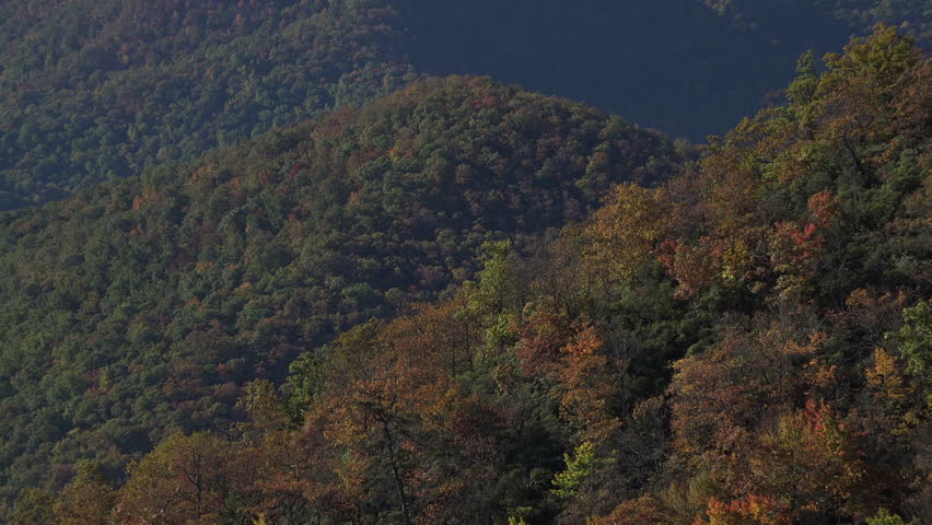 Zoom out from sign of Big Ridge overlook on Blue Ridge Parkway road near Asheville, NC, USA