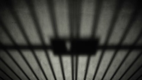 Prison cell door closing shadow on dark concrete jail floor. 1920x1080 full hd footage.