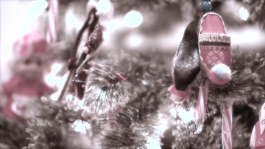 Christmas tree with lights and ornaments and presents in a home