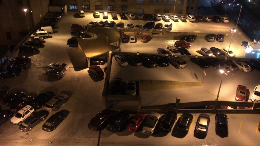 An aerial view of a crowded parking lot at night.