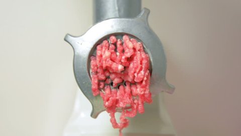 house production of forcemeat on the meat grinder close up