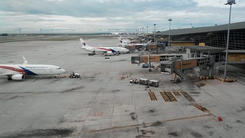 KUALA LUMPUR, MALAYSIA - DECEMBER 27: (Timelapse View) A Malaysia Airlines plane prepares for passengers to board, as ground crew prepares the plane , december 27, 2014 in KLIA, Malaysia.