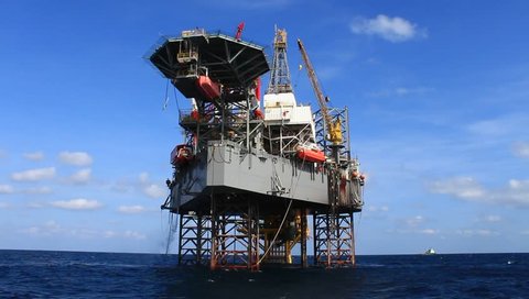 Jack up drilling rig in the middle of the ocean view from the crew boat

