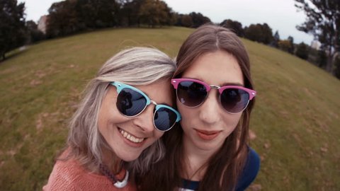 Mother and daughter having fun whilst posing and being silly for a selfie
