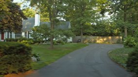 Driving plate: left side (passenger view), upscale 1950s-era homes in an affluent Mid West US neighborhood.  Intended for compositing.  24mm lens, stabilized clip, moderate speed, recorded in 4K, UHD
