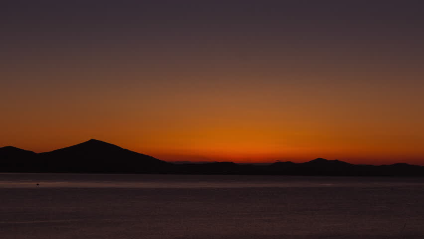 4K scenic sunrise background sun rising.
Wide view timelapse of sun rising behing sea and mountains in Greece.
All unwanted elements been digitally removed,and sequence has been deflickered.