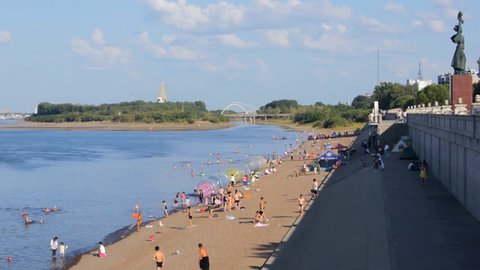 AUGUST 23, 2014 - Heihe Heilongjiang River Beach 02. River Heilongjiang (Amur), beach on the shore, people resting and swimming. Sunny summer day of August 23, 2014. Town of Heihe, China. 