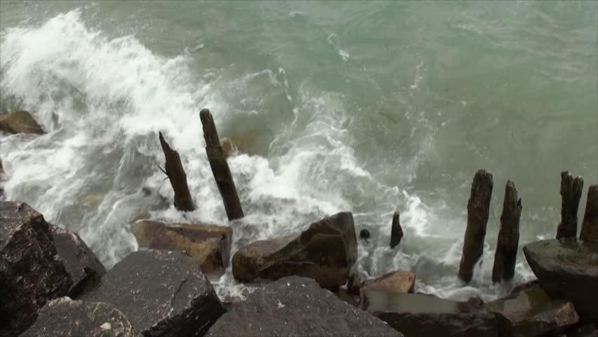 Close up of waves shaming rocky shore at Lake Michigan. The film was shot in late September on a cloudy and windy day.