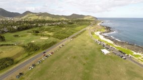 Drone elevation footage of Oahu south shore, including parts of Sand Beach and Makapuu Point, and kites flying in the air.