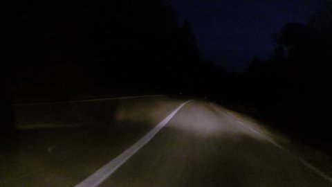 Car driving at night on country road