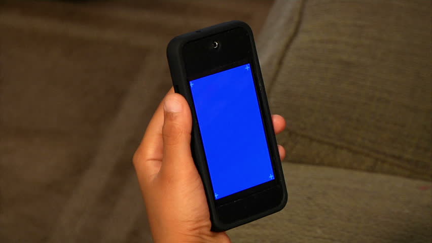 Holding a mobile smartphone.  Blue screen for your custom video content with