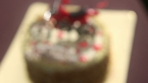 close up Birthday cake with nuts and vanilla cream decorated with motorcycle figure, red stars and words Happy Birthday