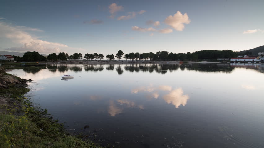 4k Time lapse of tree lined beach in galicia at sunset

