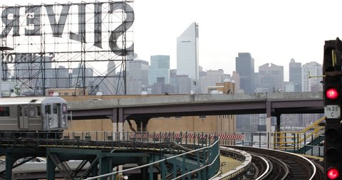 NEW YORK CITY, USA - APRIL 23, 2013 Underground Subway Train Passing Elevated Line in Queens NYC Skyline, Establishing Shot ( Ultra High Definition, UltraHD, Ultra HD, UHD, 4K, 2160P, 4096x2160 )