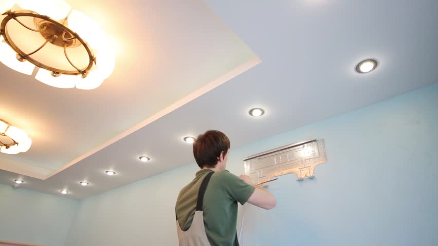 Man installs air conditioning in the new modern room