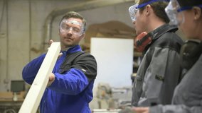 Carpenter instructor with students in workshop