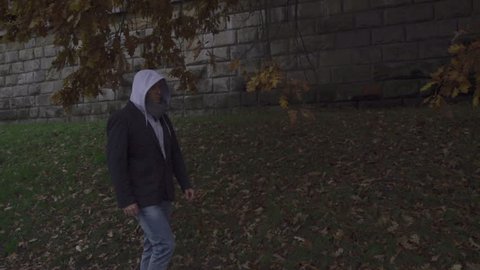 Man in hoodie walking on wintry day, steadycam shot, slow motion shot at 240fps
