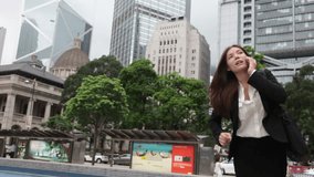 Stress - business woman running talking on smartphone stressed and rushing in a hurry. Mixed race Asian / Caucasian businesswoman stressing and busy. Video from Hong Kong Central.