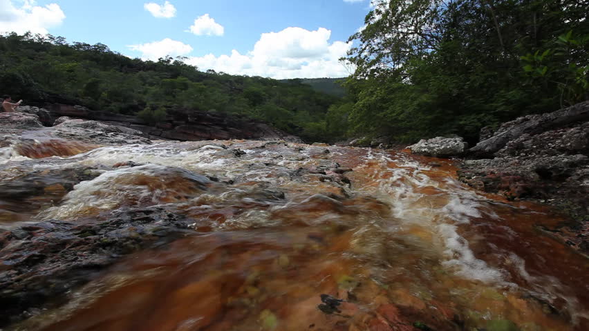 Three scenes of dark red water of a brazilian river, shot in the Chapada