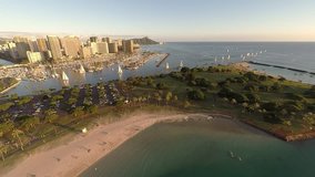 Aerial video over Ala Moana Beach Park, shopping center, and Magic Island and Ala Wai Boat Harbor in Honolulu, Hawaii near Waikiki