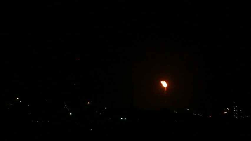 view on petrochemical factory with flame at night