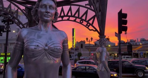 HOLLYWOOD, CA - December 24, 2014: silver "Four Ladies of Hollywood" gazebo on Hollywood Walk of Fame at sunset. Vertical camera pan.