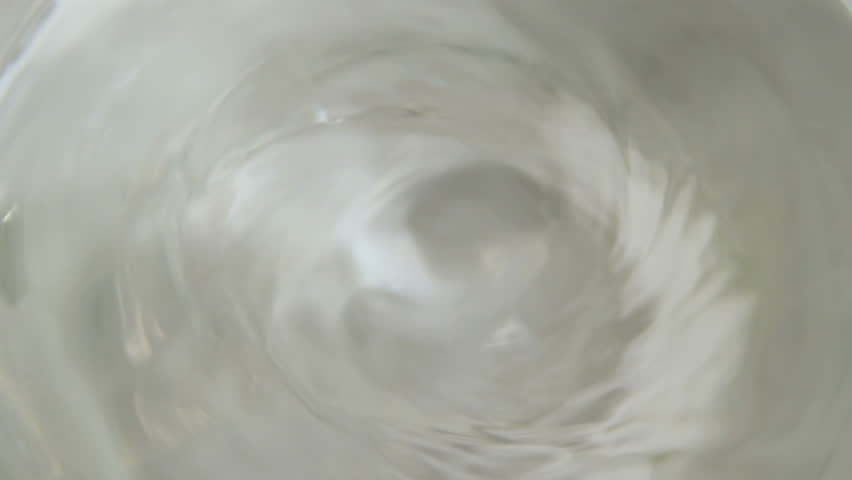a clear chemical swirling in a beaker