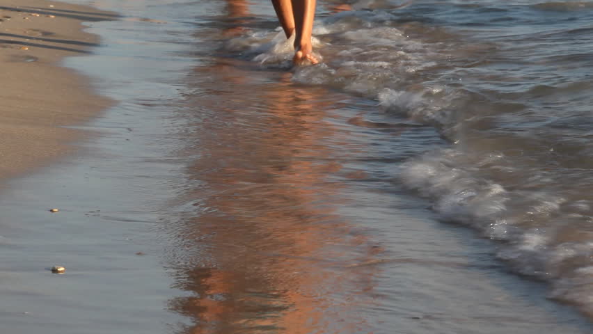 woman walking along the beach. 