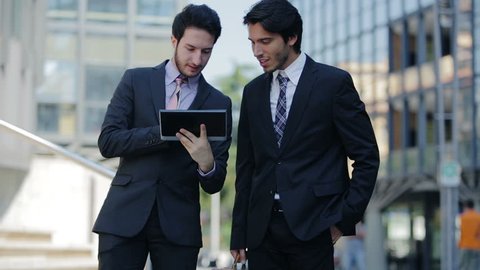 business people debating about work on a tablet computer
