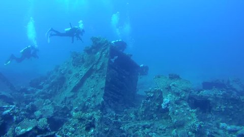 Scuba divers inspect the wreckage of wreck ship SS Carnatic in Red Sea, Egypt