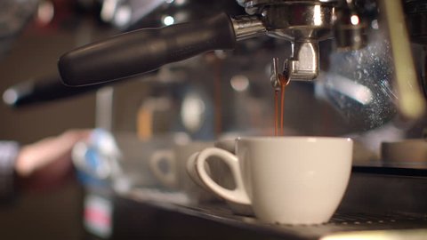 Preparing cups of espresso at a busy coffee shop