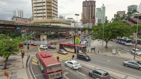 Kuala Lumpur, Malaysia - December 14 2014: Cars rush Pudu Raya street along the elevated train line in Malaysia capital city, Kuala Lumpur. 