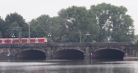 HAMBURG, GERMANY - JULY 6, 2014 S-Bahn Train Pass Cross Bridge Busy City Cars Traffic Commuters Commute Establishing Shot ( Ultra High Definition, UltraHD, Ultra HD, UHD, 4K, 2160P, 4096x2160 )