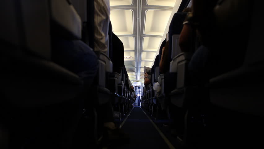 A plane from inside on a regular flight, people are seated and ready for take
