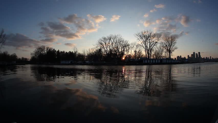 flowing water at sunset near urban area