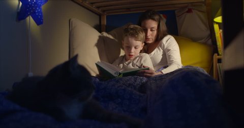 Bedtime story reading mum and 7 year old son