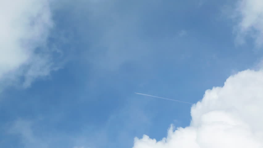 Aircraft trail between two clouds