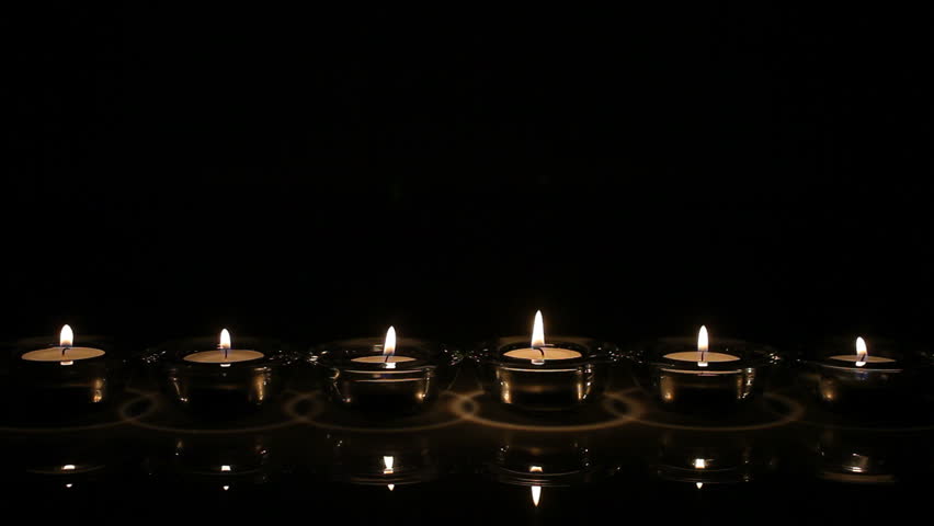 Six flickering candles in row
