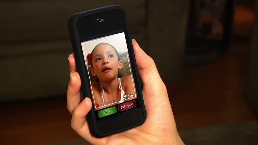 Video chatting on a portable hand-held device.  Screen images simulated.